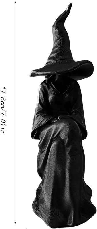 Witch reading figurine